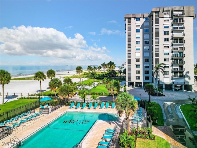 view of pool featuring a patio area and a water view