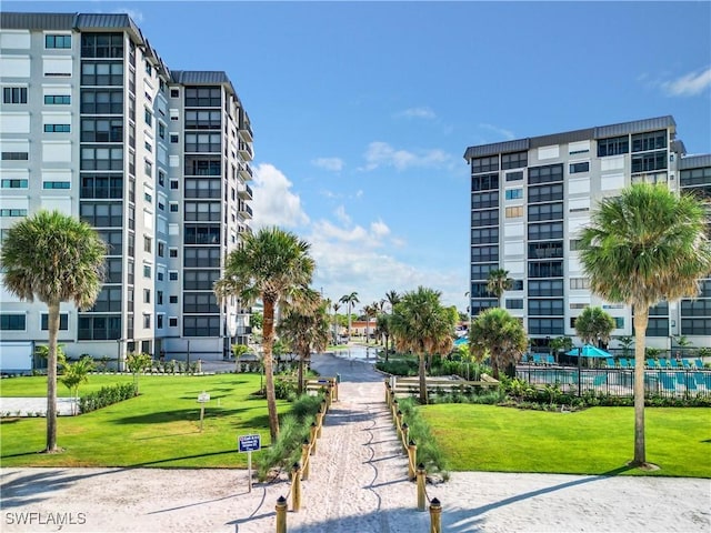 view of property's community with a lawn