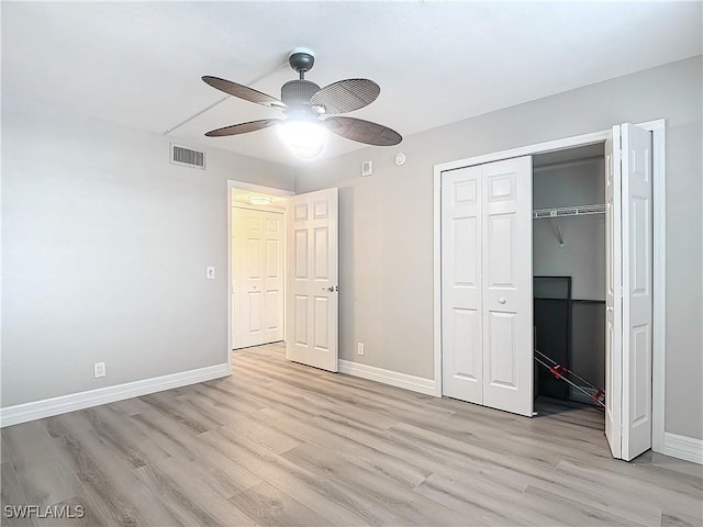 unfurnished bedroom with ceiling fan, a closet, and light hardwood / wood-style flooring