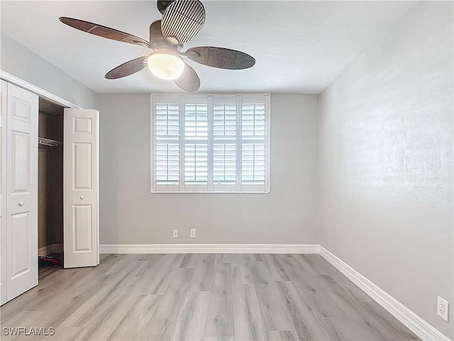 unfurnished bedroom with ceiling fan, a closet, and light hardwood / wood-style floors