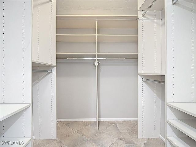 spacious closet featuring light tile patterned flooring