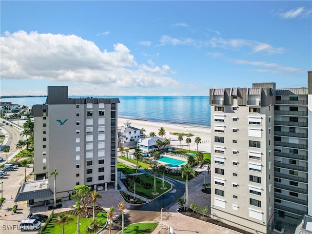 birds eye view of property featuring a water view and a beach view