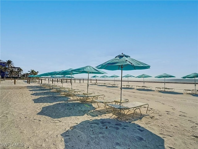 surrounding community featuring a water view and a view of the beach