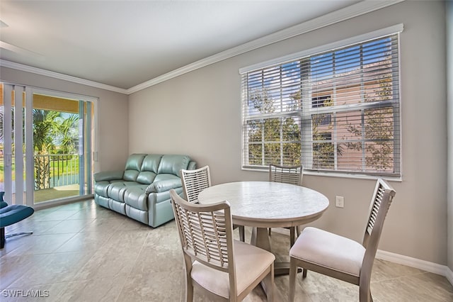 dining area with light tile patterned floors and crown molding