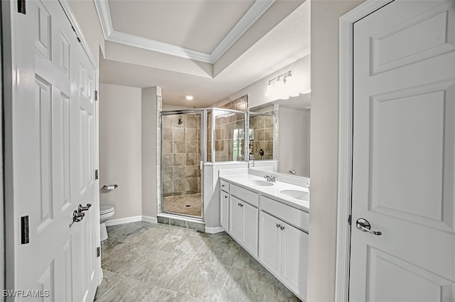 bathroom with vanity, toilet, a shower with shower door, and crown molding