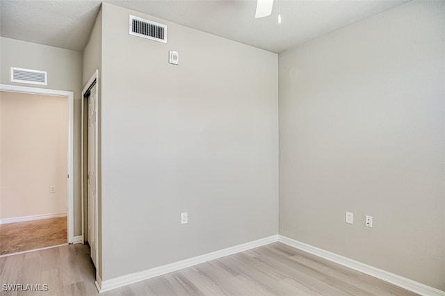 spare room featuring ceiling fan and light hardwood / wood-style floors