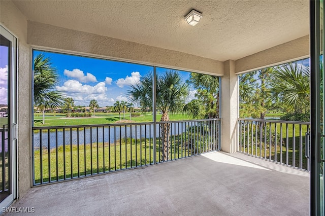 unfurnished sunroom with a water view