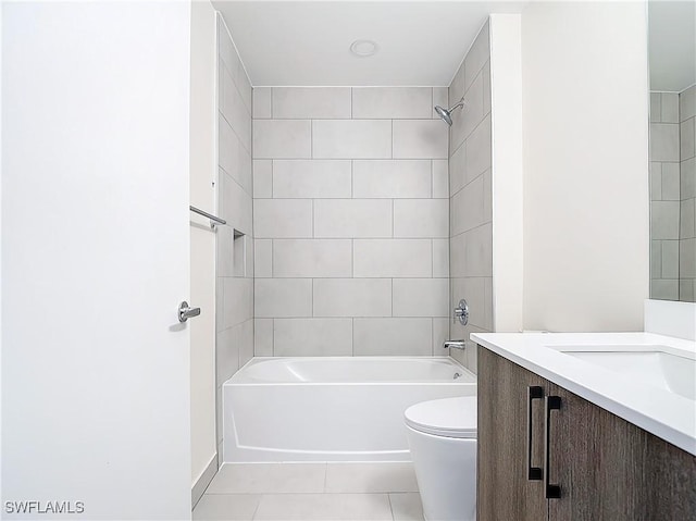 full bathroom featuring vanity, tile patterned flooring, tiled shower / bath combo, and toilet