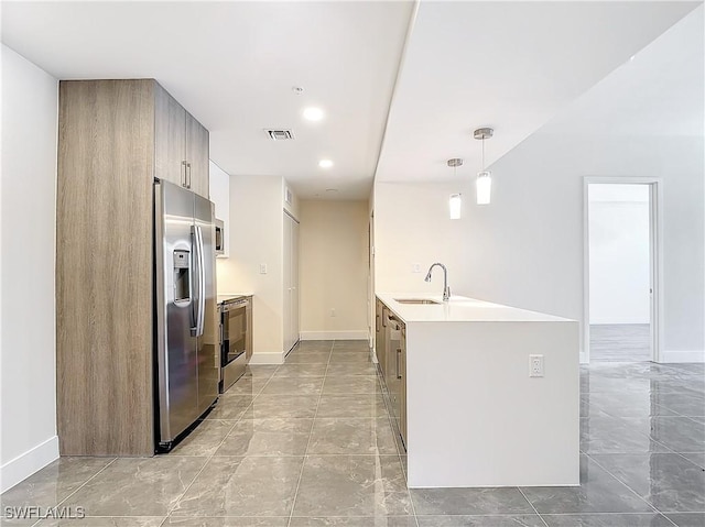 kitchen with hanging light fixtures, appliances with stainless steel finishes, and sink