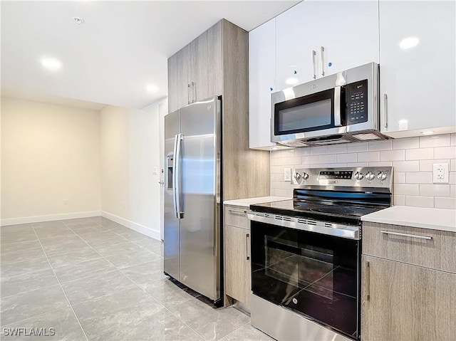 kitchen with tasteful backsplash and stainless steel appliances