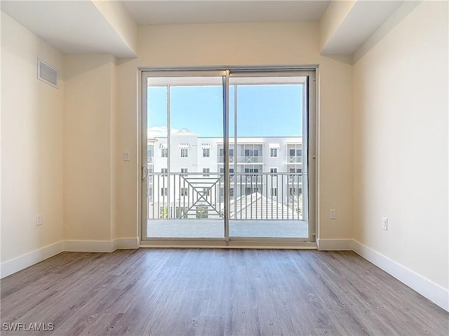 spare room featuring light hardwood / wood-style flooring