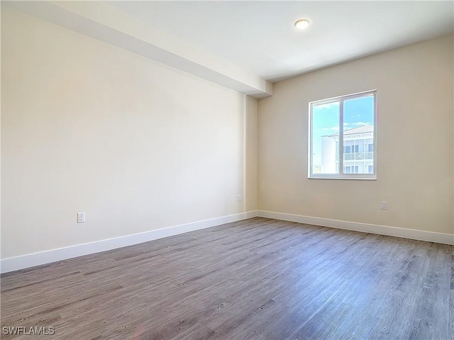 spare room with hardwood / wood-style flooring