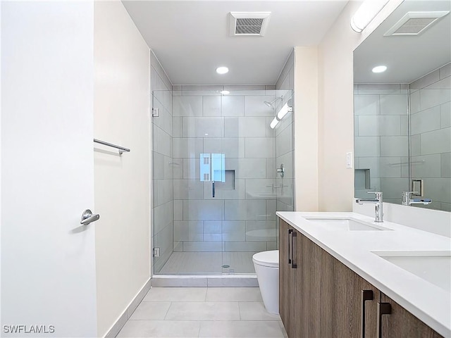 bathroom featuring vanity, toilet, an enclosed shower, and tile patterned flooring