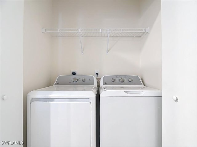 washroom with washing machine and clothes dryer