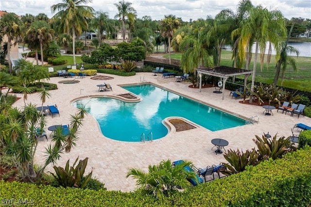 view of pool featuring a pergola, a patio area, and a water view