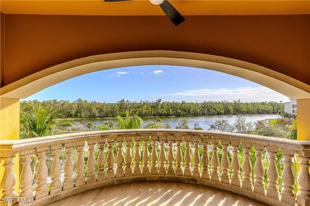 balcony with ceiling fan and a water view