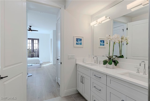 bathroom with ceiling fan and vanity