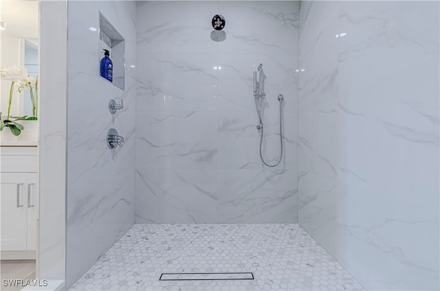 bathroom with vanity and tiled shower