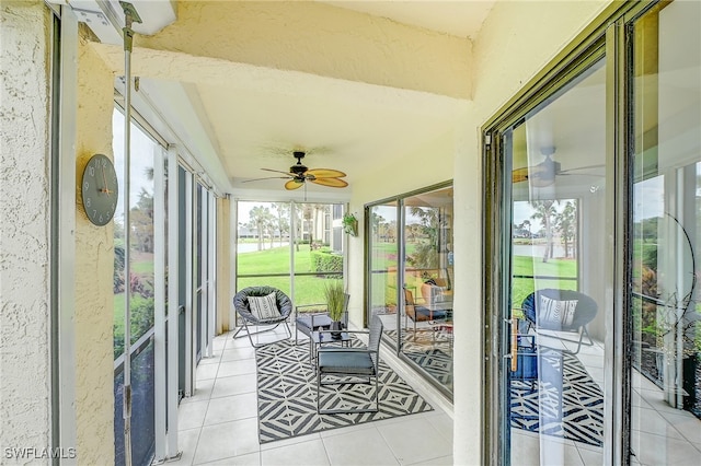 sunroom / solarium with ceiling fan and a healthy amount of sunlight