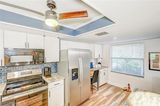 kitchen with crown molding, tasteful backsplash, light hardwood / wood-style floors, white cabinetry, and stainless steel appliances