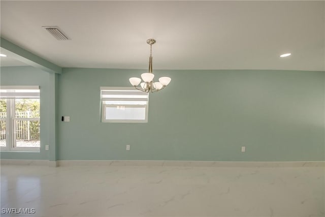 empty room with an inviting chandelier