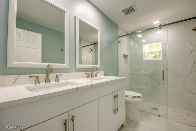 bathroom featuring vanity, an enclosed shower, and toilet