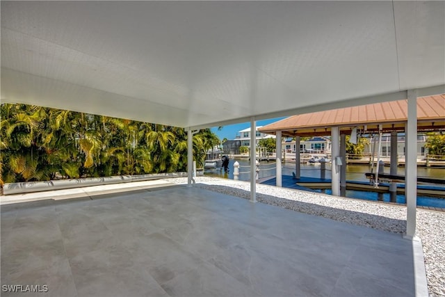 view of patio / terrace with a water view and a dock