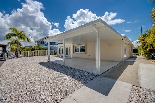 back of property with cooling unit and a patio