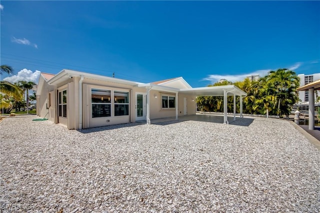 back of house with a carport