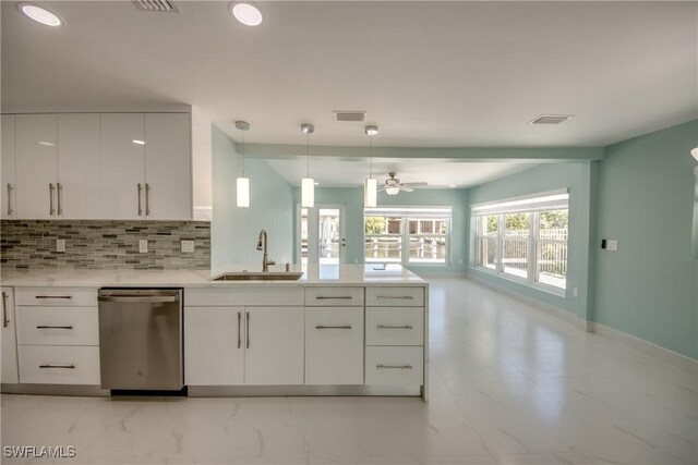 kitchen featuring backsplash, white cabinets, sink, decorative light fixtures, and dishwasher