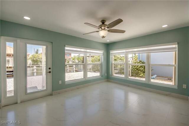 interior space with ceiling fan