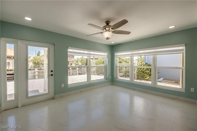 interior space with ceiling fan