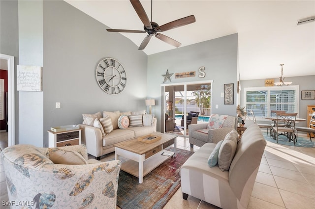 tiled living room featuring ceiling fan and vaulted ceiling