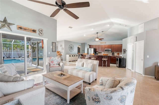 tiled living room with vaulted ceiling and ceiling fan