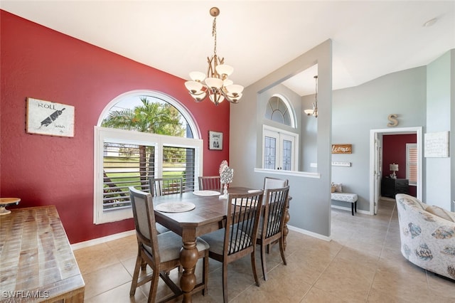 dining space featuring high vaulted ceiling, light tile patterned floors, and a chandelier