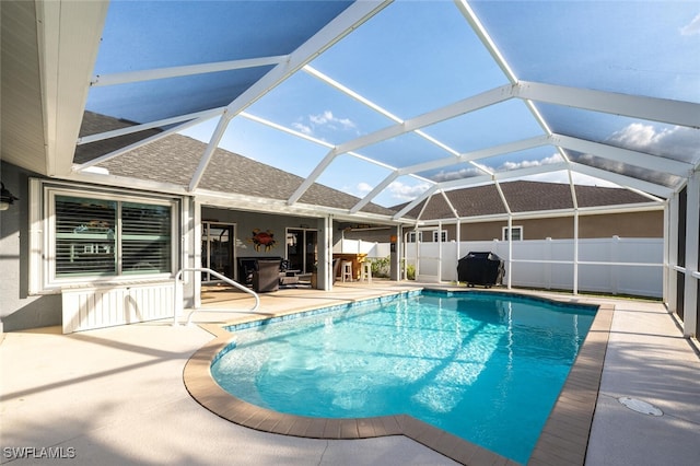 view of pool featuring a lanai, a patio, and grilling area