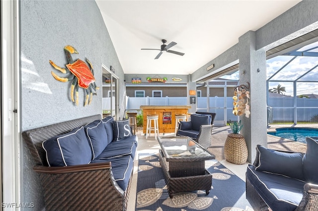 view of patio / terrace featuring a lanai, exterior bar, a fenced in pool, and outdoor lounge area