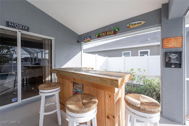 interior space with lofted ceiling and butcher block countertops