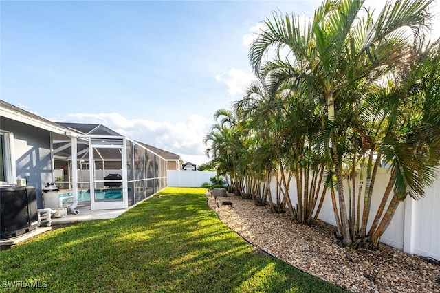 view of yard featuring glass enclosure and a fenced in pool