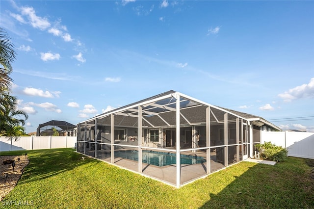 view of pool featuring a lanai, a patio, and a yard