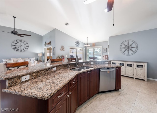 kitchen featuring sink, stainless steel dishwasher, lofted ceiling, and light stone countertops