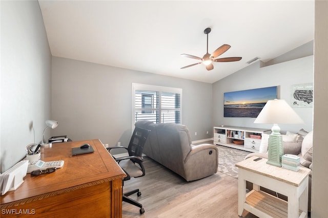 home office with ceiling fan, vaulted ceiling, and light hardwood / wood-style flooring