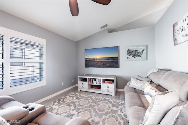 living room featuring ceiling fan, vaulted ceiling, and hardwood / wood-style floors