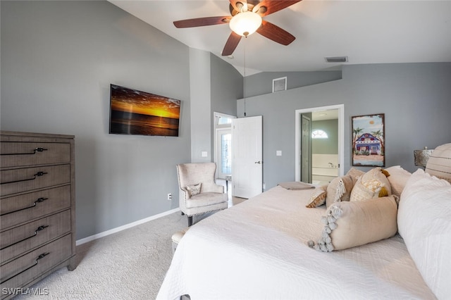 bedroom featuring ceiling fan, ensuite bathroom, vaulted ceiling, and light carpet