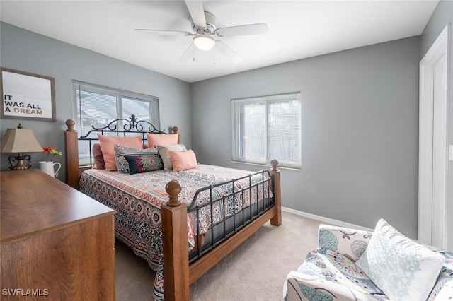 bedroom featuring ceiling fan and light carpet