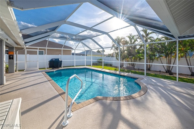 view of swimming pool with a lanai, a patio, and a grill