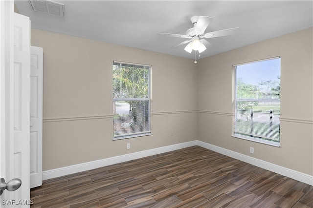 spare room featuring dark hardwood / wood-style flooring and ceiling fan