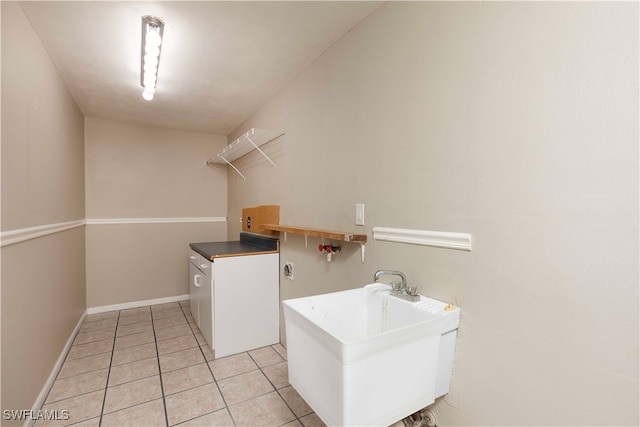 washroom featuring hookup for a washing machine and light tile patterned flooring