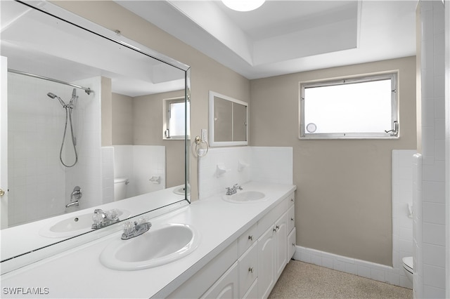 bathroom with a wealth of natural light, vanity, and toilet