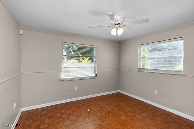 unfurnished room featuring ceiling fan, dark parquet flooring, and crown molding